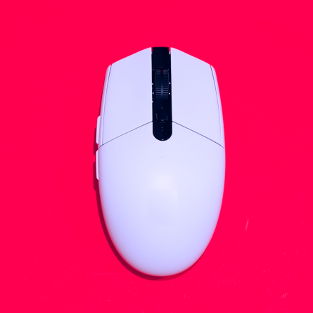 a white external computer mouse on top of a red background