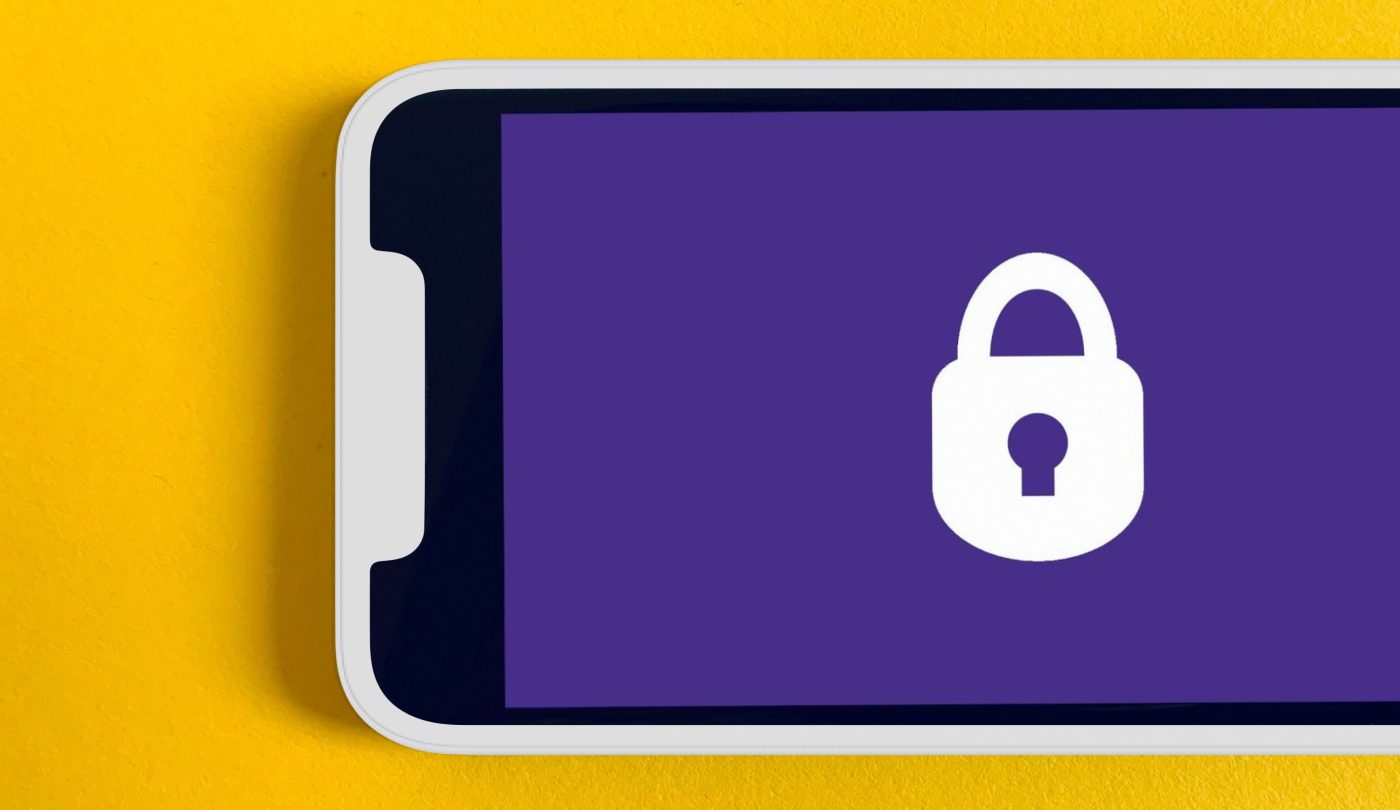 An iphone in a white case shows an icon of a lock on a purple background