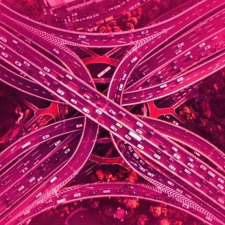 Artistic photo of a highway cloverleaf interchange with a rose-colored overlay.
