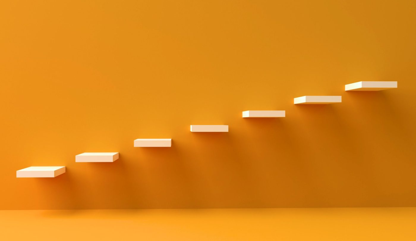 Symbolic photo of stairs against a vibrant yellow background.