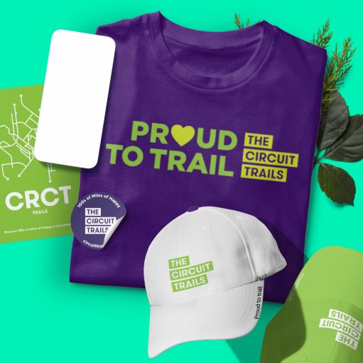New branding and logo for Circuit Trails as shown on a t-shirt, hats, and print materials with the tagline 