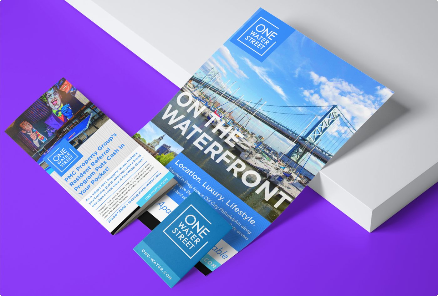 Rebranded print materials including a brochure, business card, and flyer for the One Water Street property.
