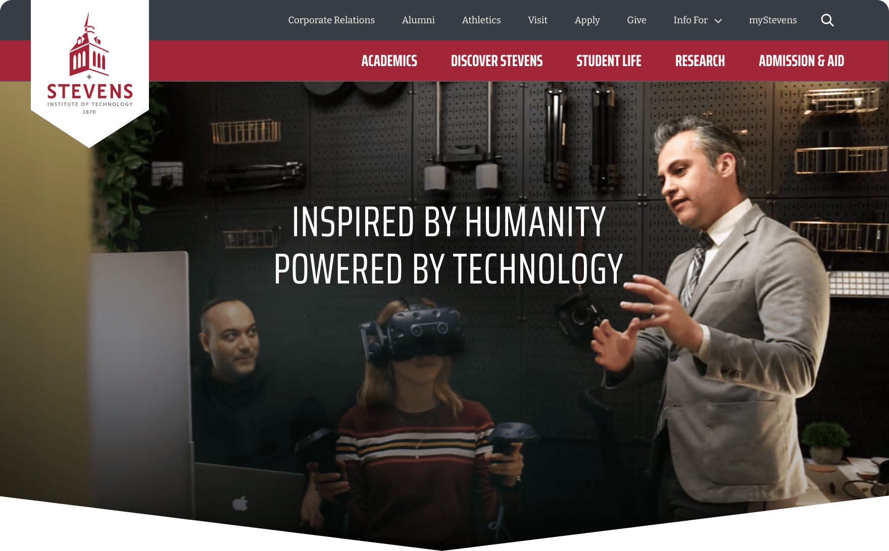 Homepage of Stevens Institute of Technology featuring a professor explaining VR equipment to students, with the tagline ‘Inspired by Humanity, Powered by Technology.