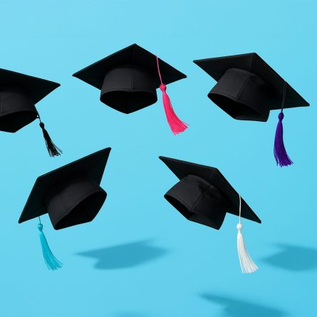 5 black graduation caps with tassels floating in the air above a pale blue background