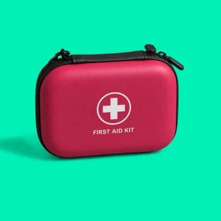 Red first aid kit with a white medical cross on a bright green background.