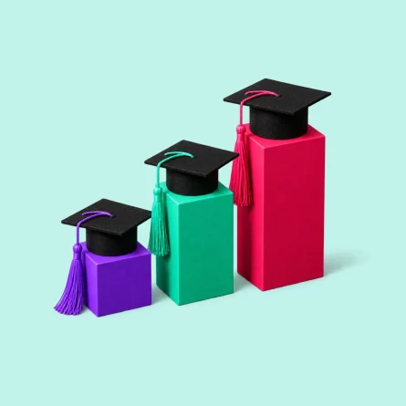 Three graduation caps on colorful ascending blocks representing competitive rankings.