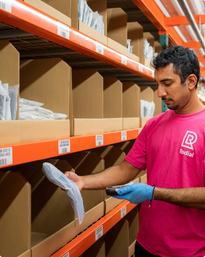 a Radial employee scanning something in a fulfillment center