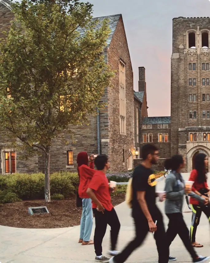 students walking around the outside of Cornell Law's stone buildings