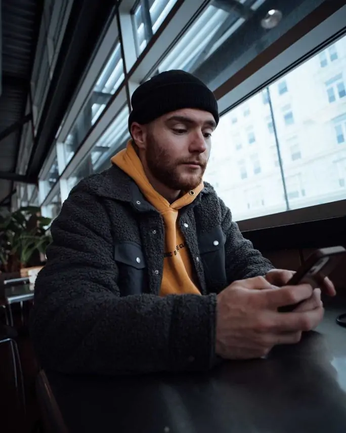 a young man looking at his mobile