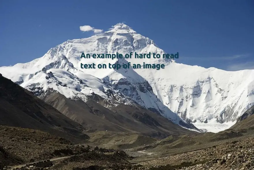 an example of hard to read text as dark green on top of a busy image of a snow-covered mountain