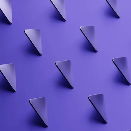 Diagonal 3D purple triangles arranged in an intriguing pattern. The diagonal orientation and 3D effect give the triangles a sense of depth and movement.