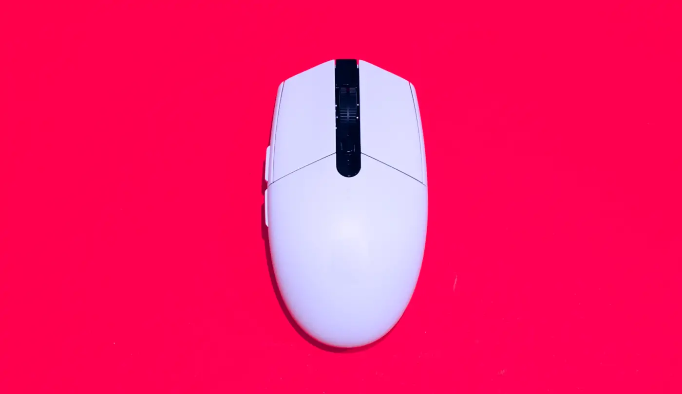 a white external computer mouse on top of a red background