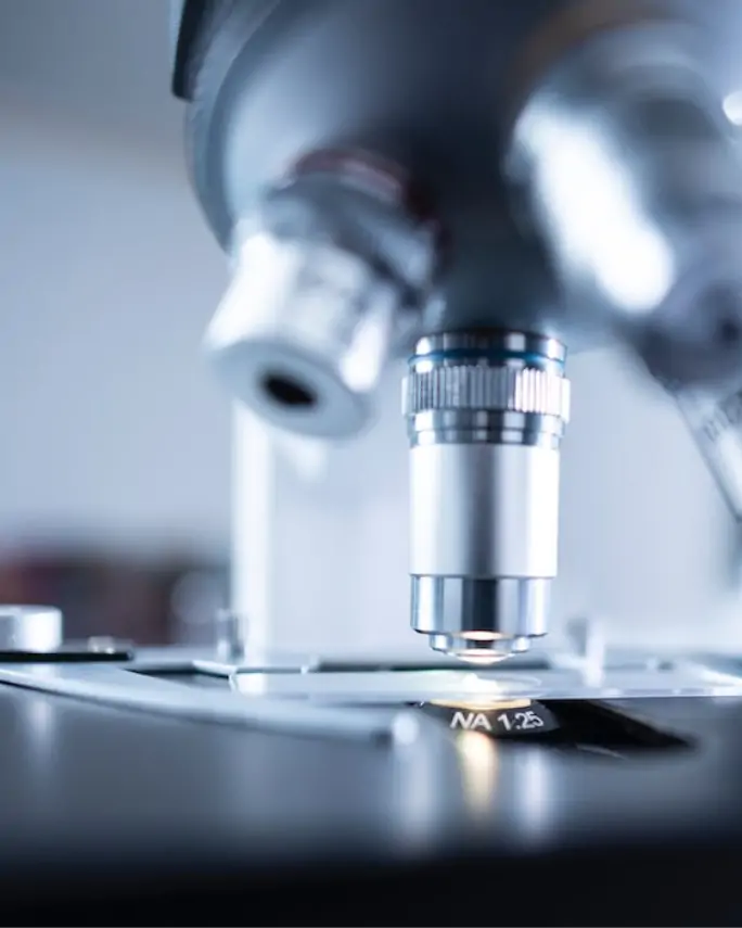 closeup of a microscope examining a slide