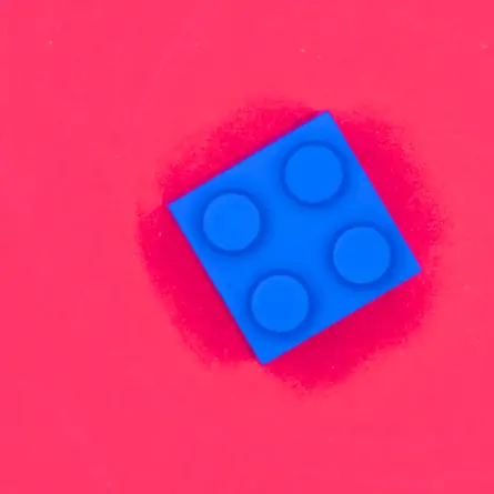 Bright rose-red background and a single square blue LEGO piece positioned to the right