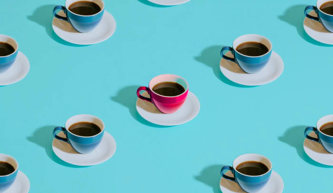 Rendered image of a grid composed of turquoise-colored tea cups, with a distinct rose-colored tea cup positioned at the center, creating a focal point within the composition.
