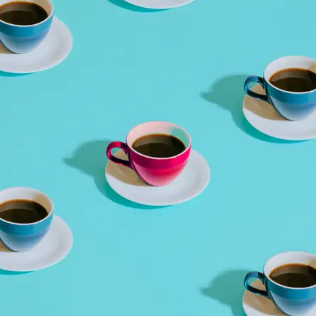 Rendered image of a grid composed of turquoise-colored tea cups, with a distinct rose-colored tea cup positioned at the center, creating a focal point within the composition.