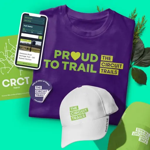 New branding and logo for Circuit Trails as shown on a t-shirt, hats, and print materials with the tagline 