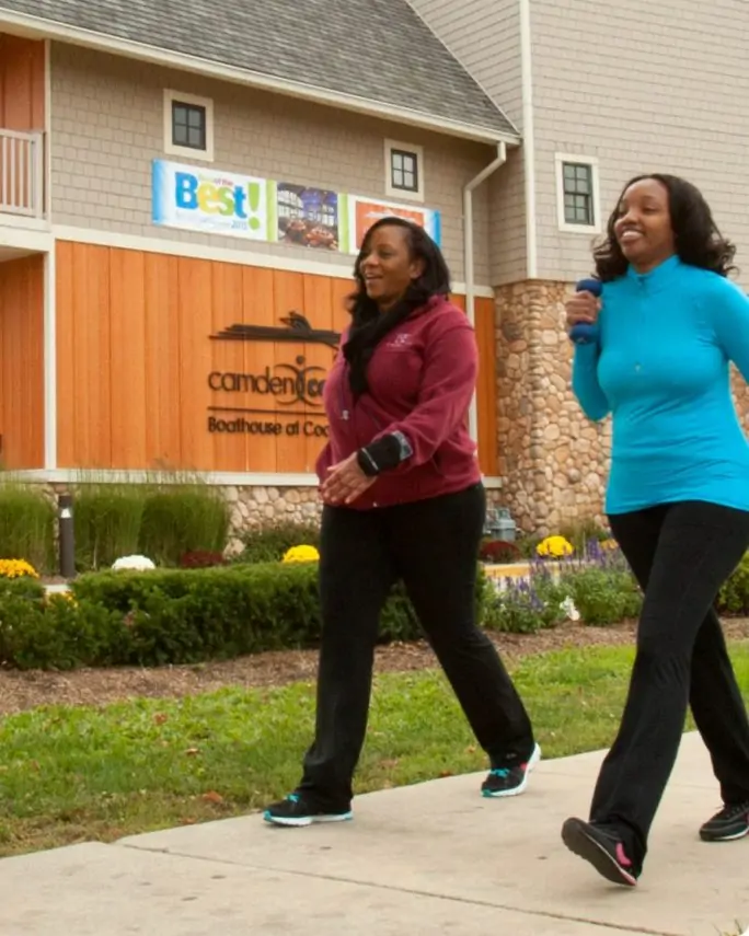 Two people walk down a trail in Camden, New Jersey