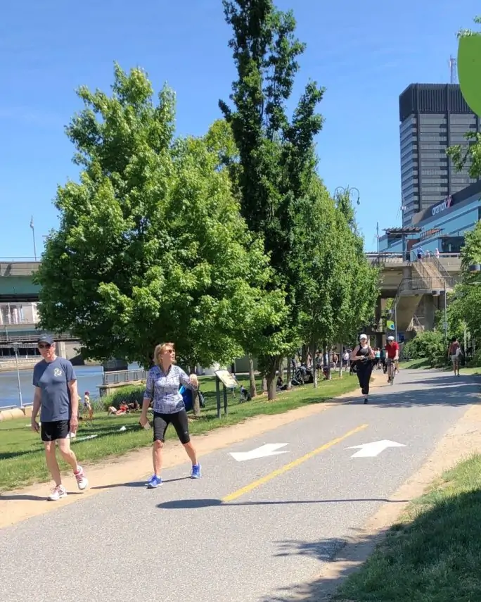 Two people walk down the trail near the Schuykill River in Philadelphia