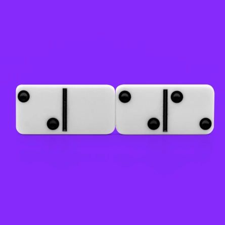 Two domino tiles stacked next to each other on a purple background