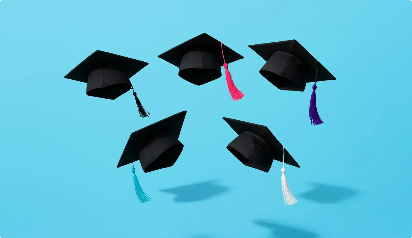 5 black graduation caps with tassels floating in the air above a pale blue background