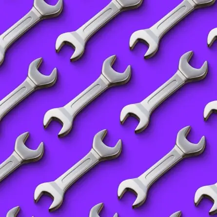 Seamless pattern of silver wrenches on a purple background, symbolizing proactive website maintenance services that keep sites secure, optimized, and performing at their best.