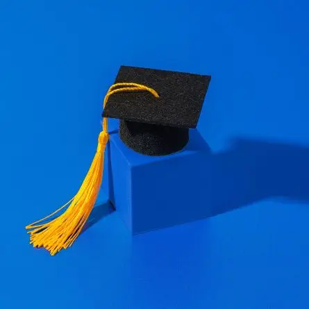 Graduation cap with tassel on a blue background representing higher education SEO and university search success.