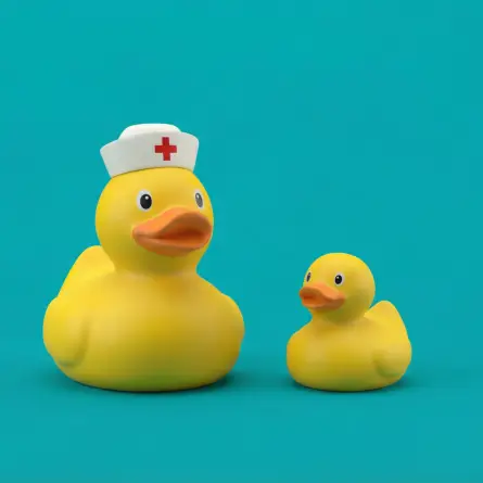 Rubber ducks with a nurse hat on a teal background representing healthcare, patient care, and approachable medical experiences.